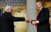 Palestinian President Mahmoud Abbas and Israeli Prime Minister Ehud Olmert shake hands at the opening of the Annapolis Conference