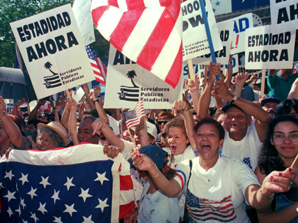 Puerto Ricans celebrating statehood referendum with American flags