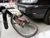 smashed bicycle next to car bumper