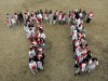 people standing in the shape of pi symbol