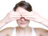 woman covering her eyes with her fingers